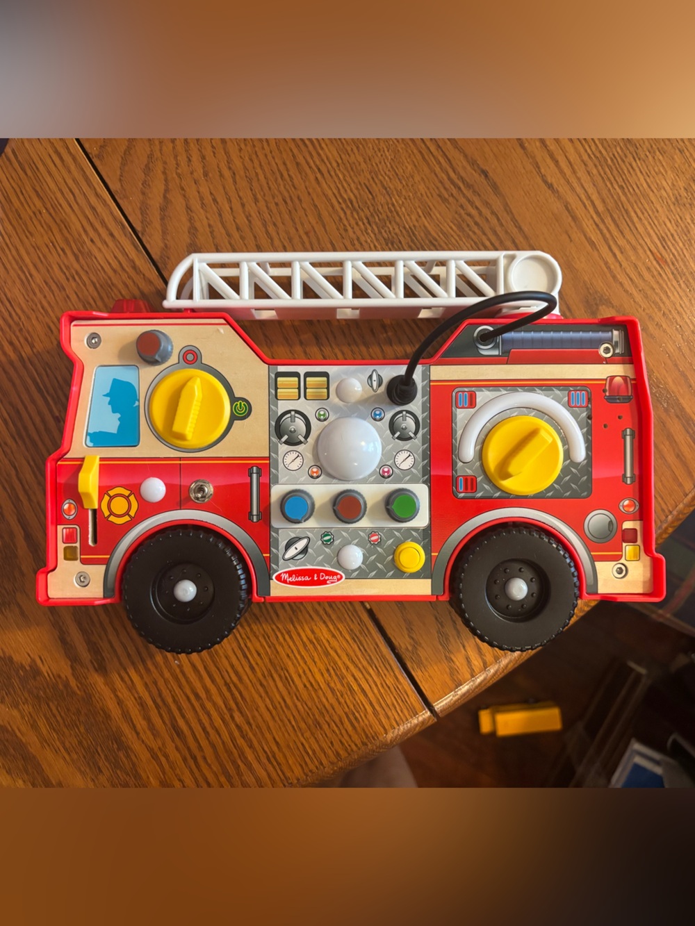 Melissa & Doug Red Fire Truck Busy Board with White Ladder and Yellow Knobs